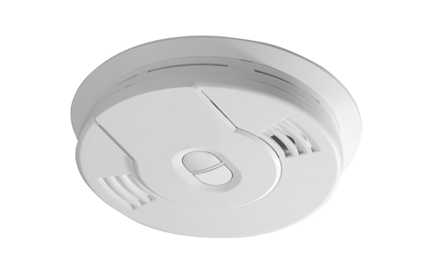 A white smoke detector. It's round and has vents.