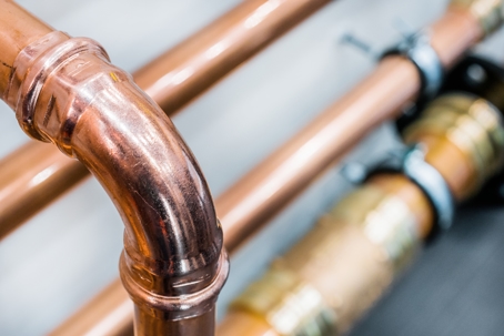 Copper pipes with elbows and fittings.