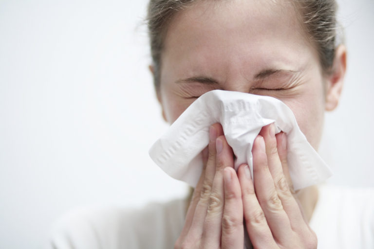Woman sneezing